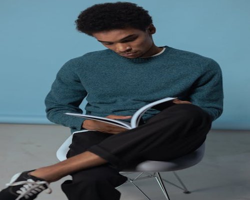 relaxed man reading book comfortable chair